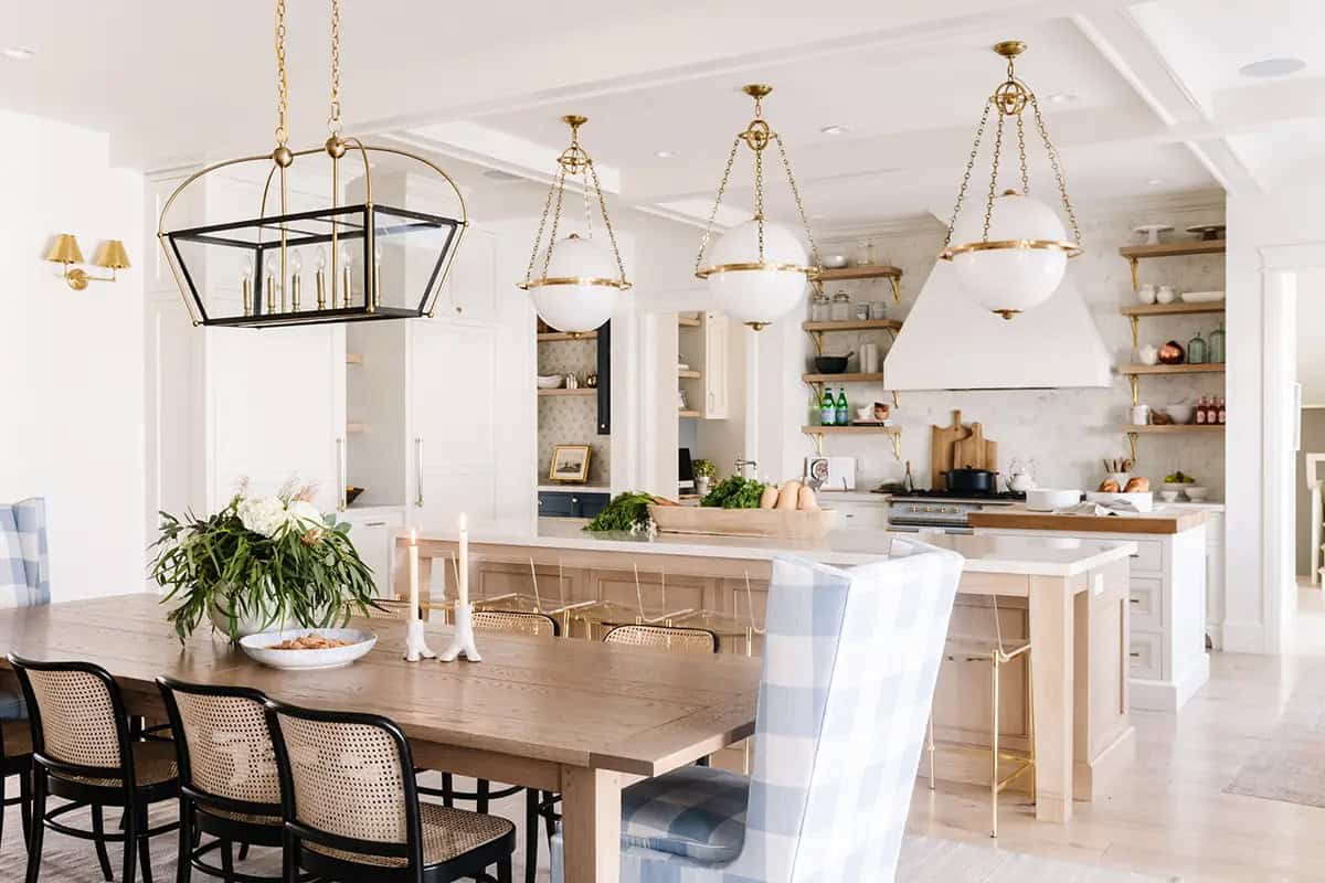 Kitchen and dining area with globe pendants, brass fixtures, wood island, and open shelving