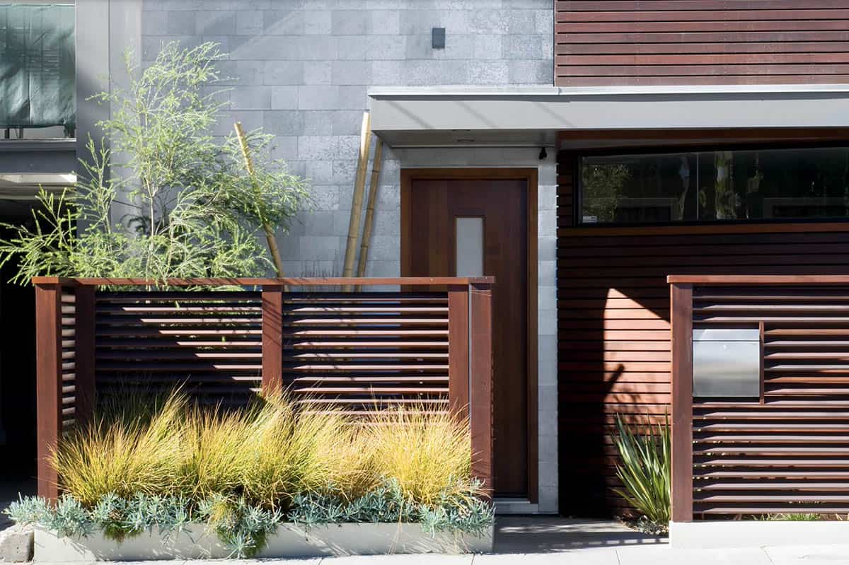 Modern narrow front yard with horizontal slat fence, ornamental grasses, succulents, and bamboo