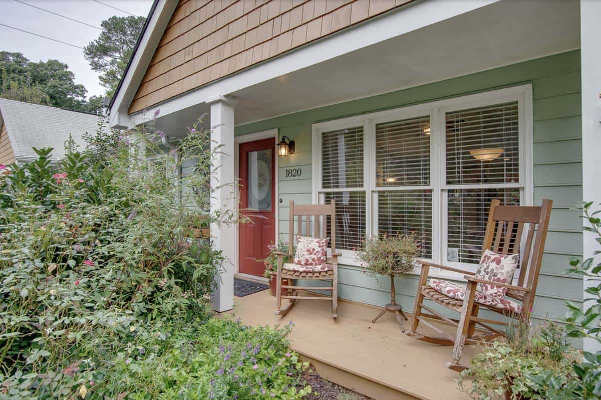 1:07 PMRailing-Free Bungalow Porch With Rocking Chairs and Garden Views