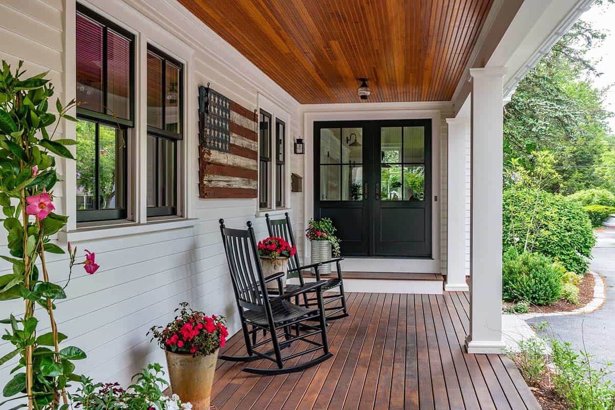 farmhouse style front porch with black rocking chairs