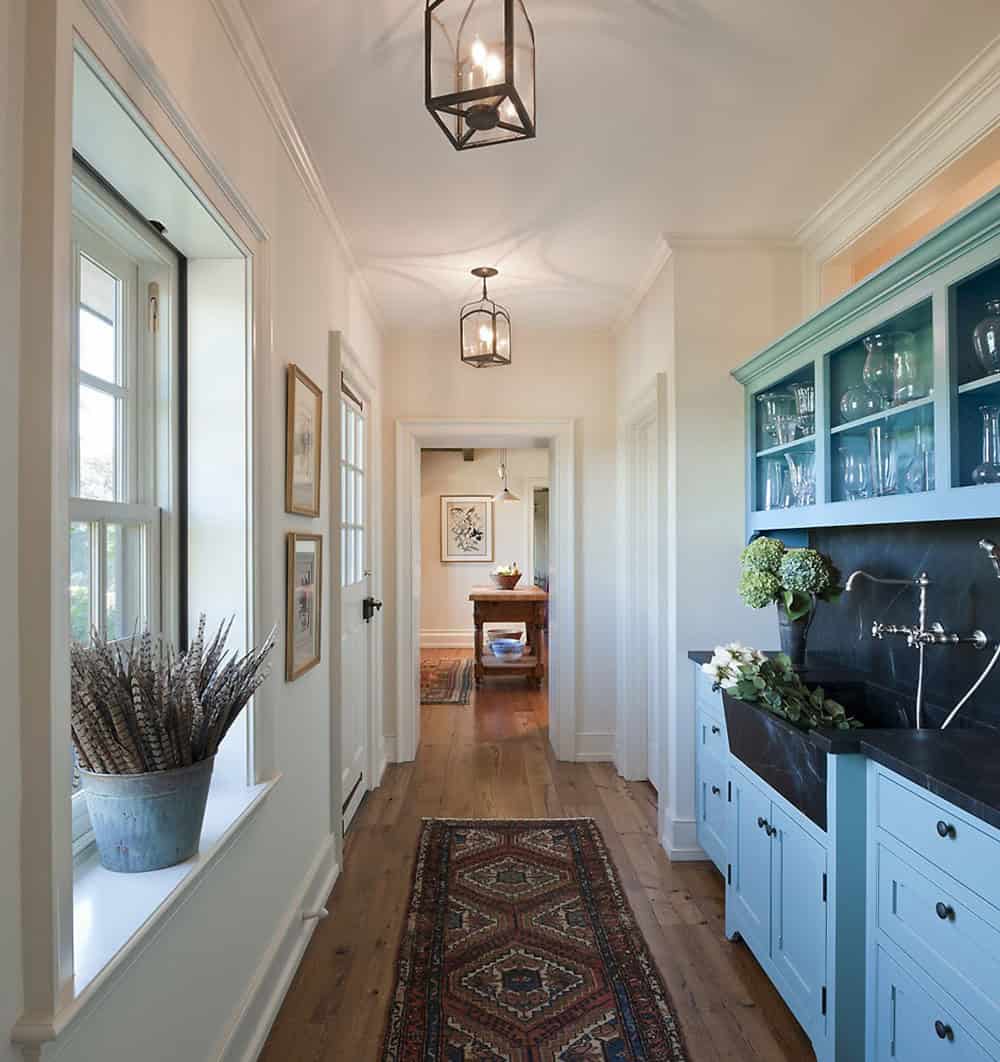 Butler's pantry with robin's egg blue cabinetry, soapstone sink, and lantern pendants