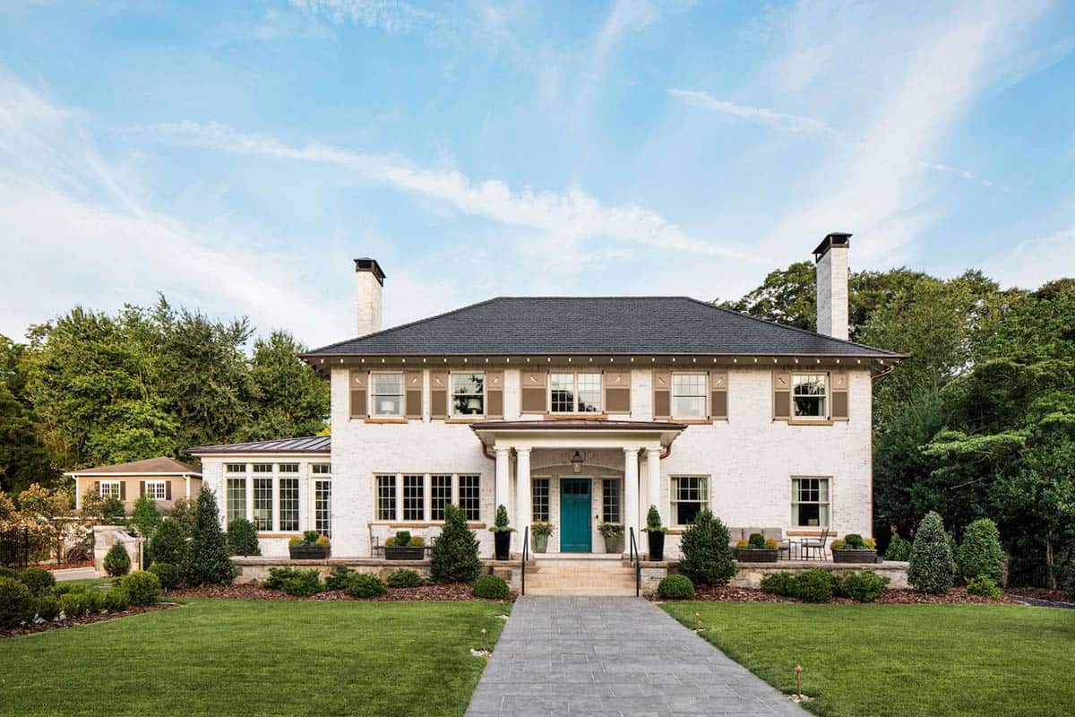 Georgian Revival white painted brick house exterior with teal front door and columned portico