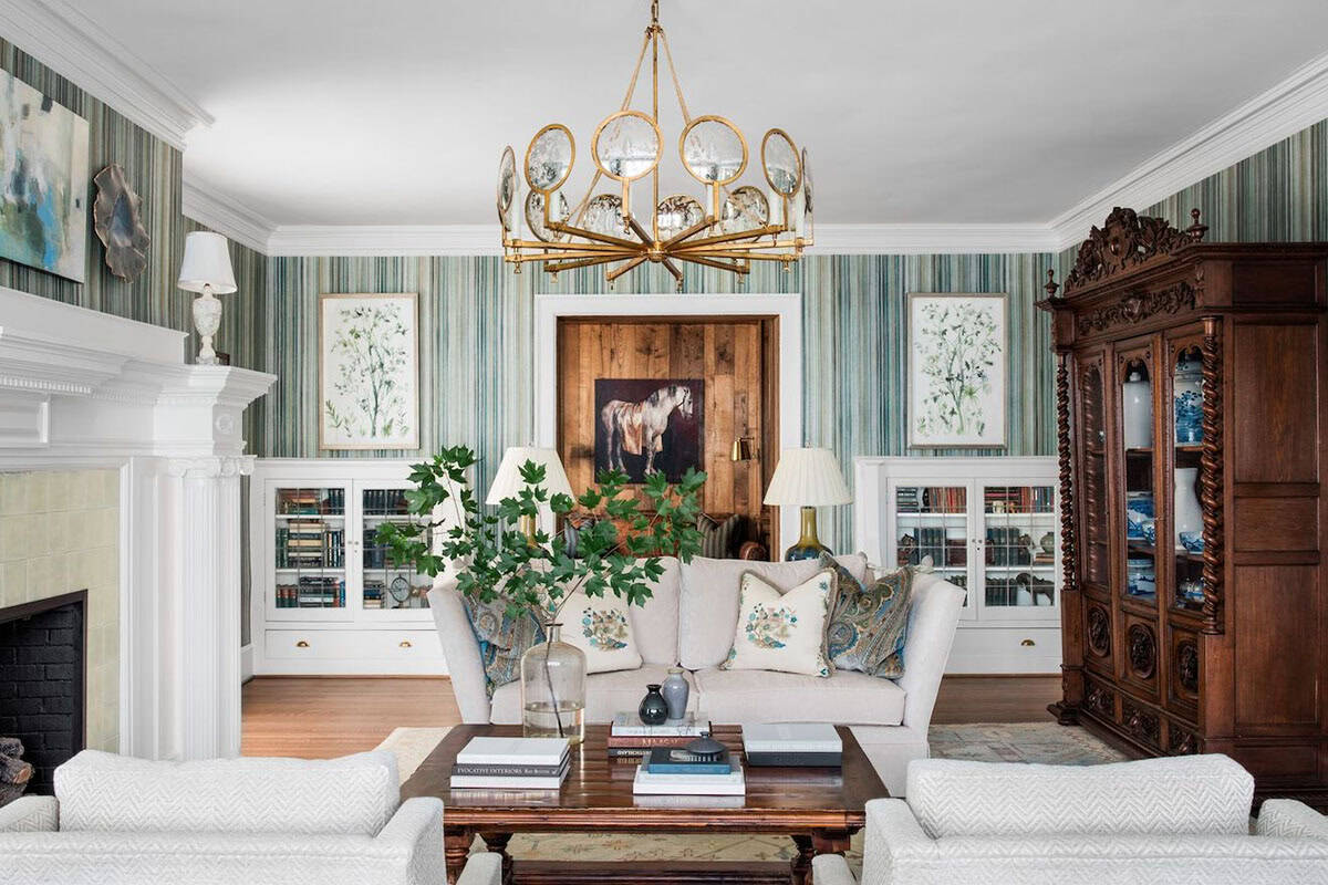 Formal living room with striped wallpaper, built-in bookcases, and ornate wood armoire