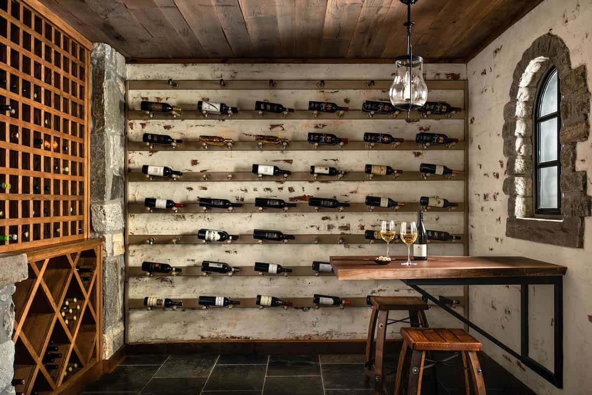 Wine cellar with wall-mounted bottle display, wooden lattice racks, and arched stone window