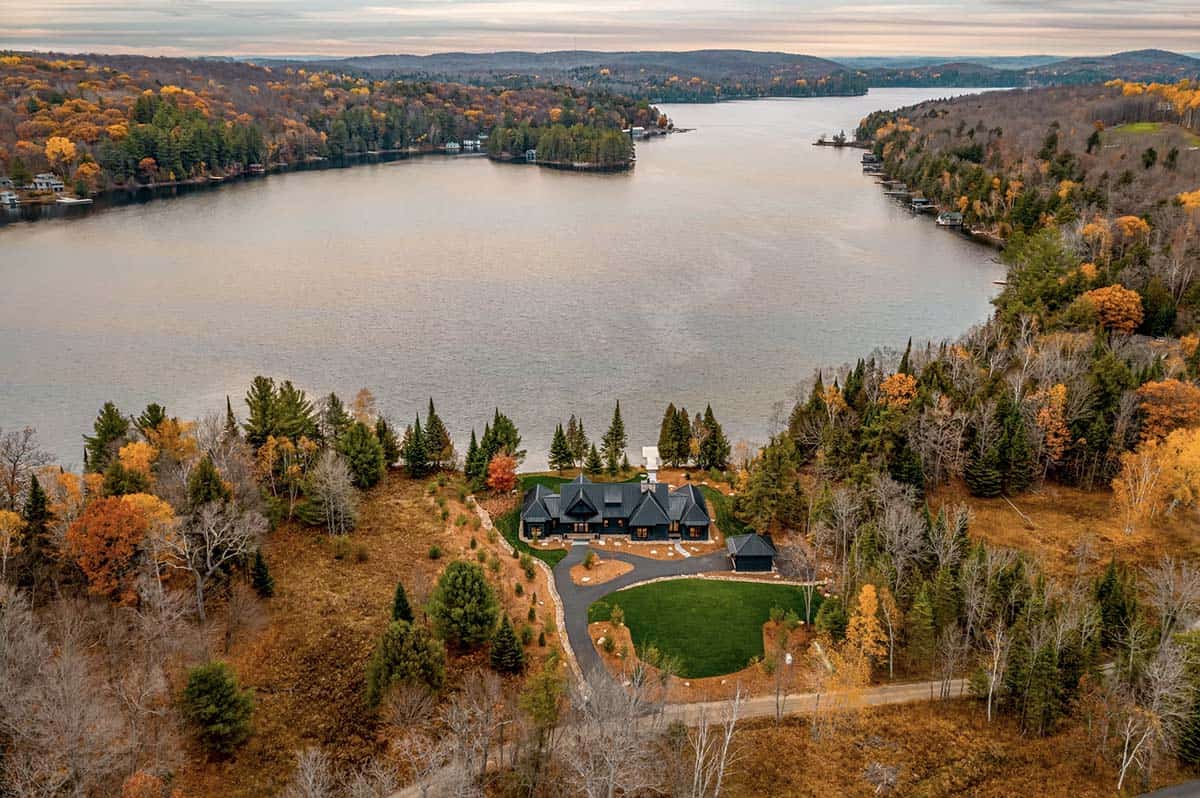 Dramatic aerial of lake cottage property adjacent to golf course with sweeping lake views