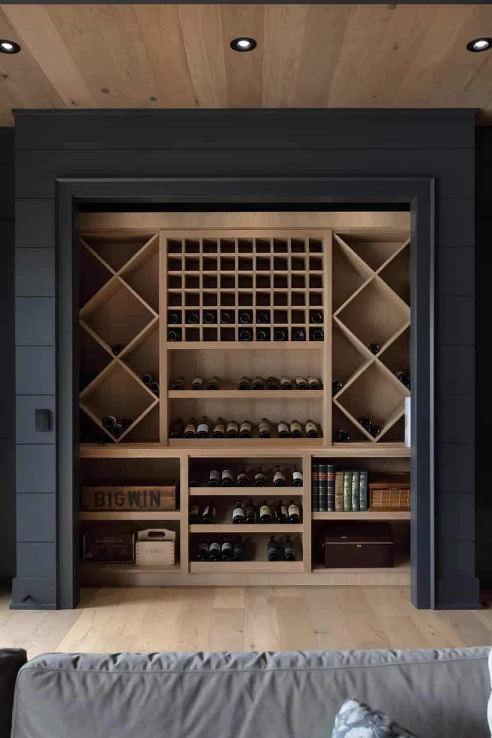 Full-view built-in wine storage wall with diamond and grid racks, framed by dark shiplap molding