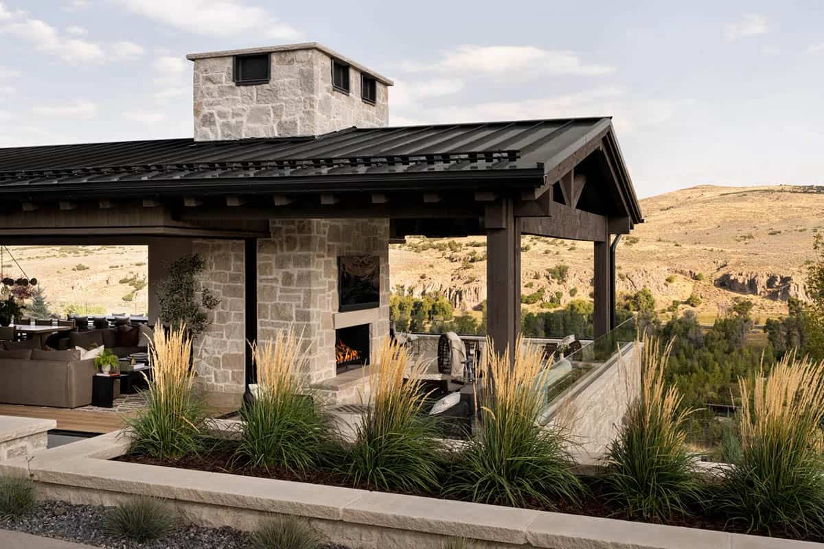 Covered outdoor pavilion with stone fireplace and canyon views