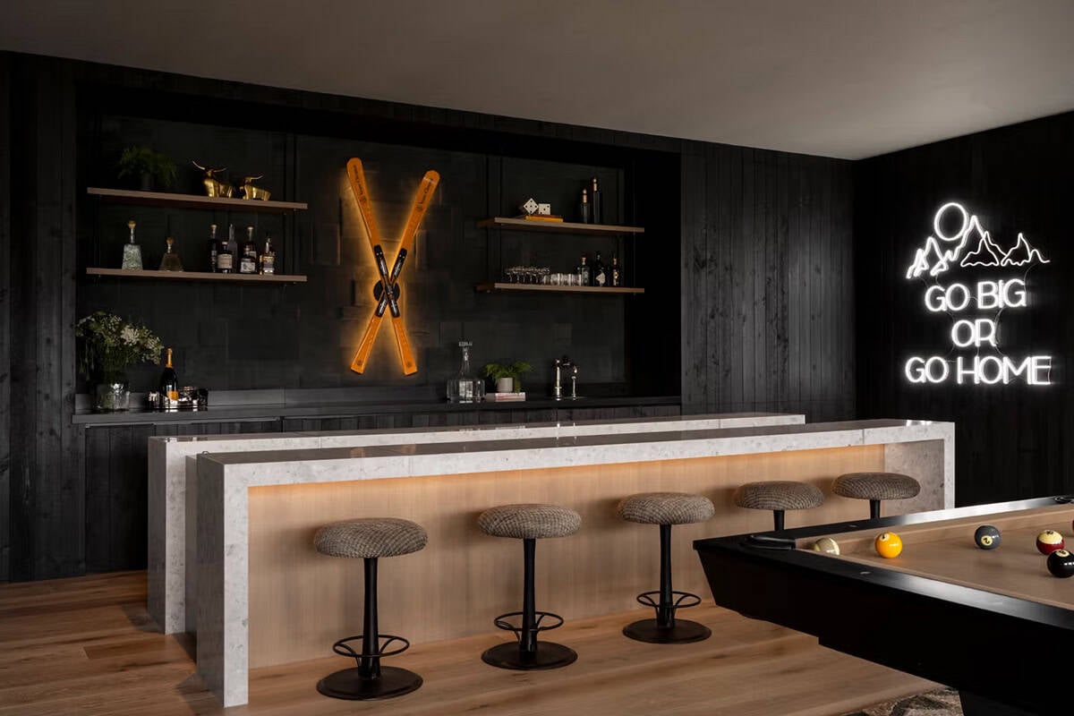 Ski-themed bar with neon signage, crossed ski art, and pool table