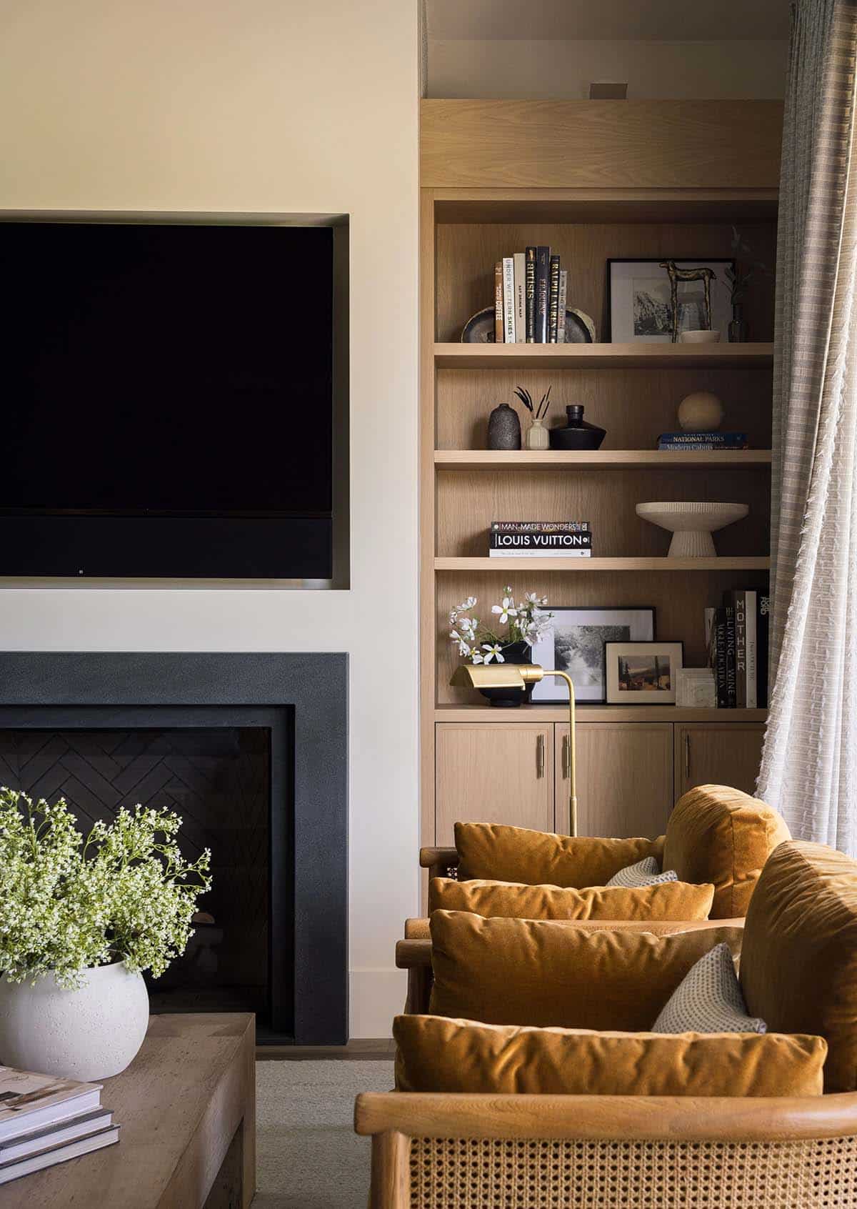 Living room fireplace with built-in oak shelving