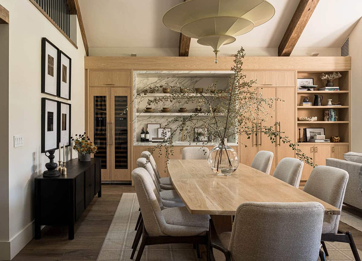 Dining room with wine fridge marble backsplash and wood cabinetry