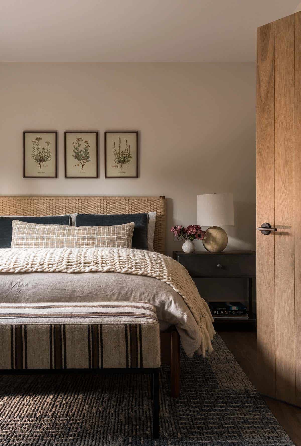Cozy bedroom with woven headboard and botanical prints
