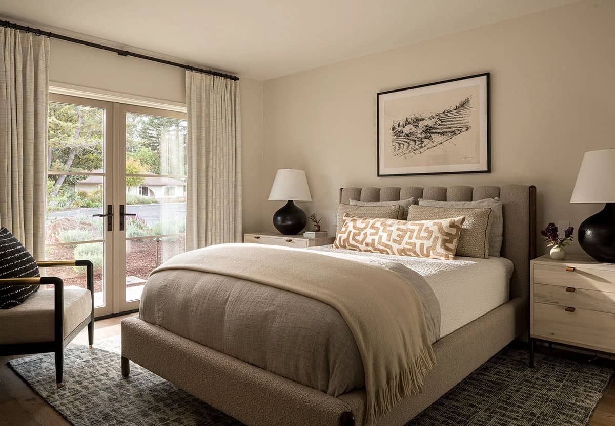 Guest bedroom with neutral tones french doors and garden view