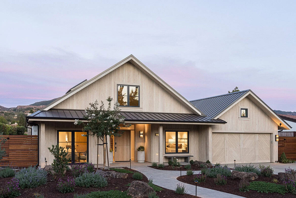 Wine country home exterior at dusk with cedar siding and metal roof