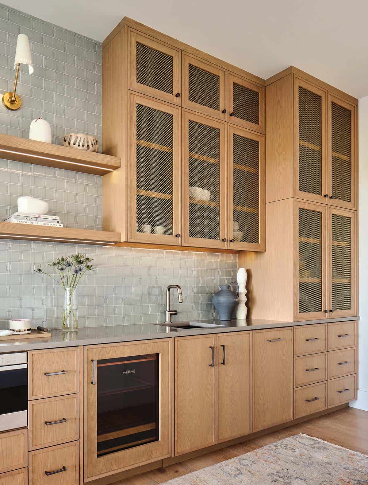 Butler's pantry with white oak mesh-front cabinetry, sage green tile backsplash, and Sub-Zero wine fridge