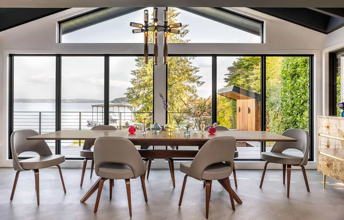Mid-century modern dining room with walnut table, Saarinen chairs, Sputnik chandelier, and lake views