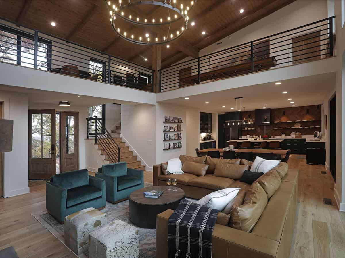 Open-plan great room with vaulted wood ceiling, loft, kitchen, and living area