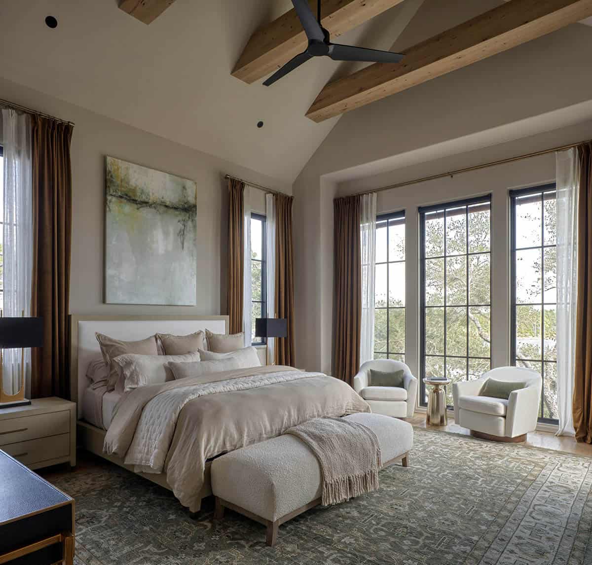 Primary bedroom with vaulted wood beam ceiling steel frame windows and sitting area