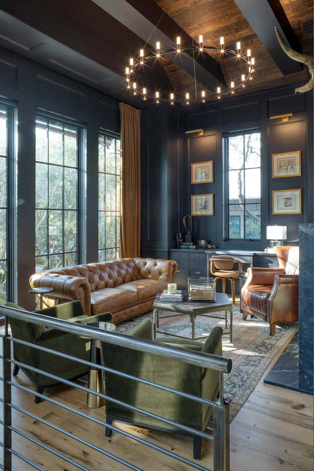 Dark moody study with leather Chesterfield sofa wood beam ceiling and statement chandelier