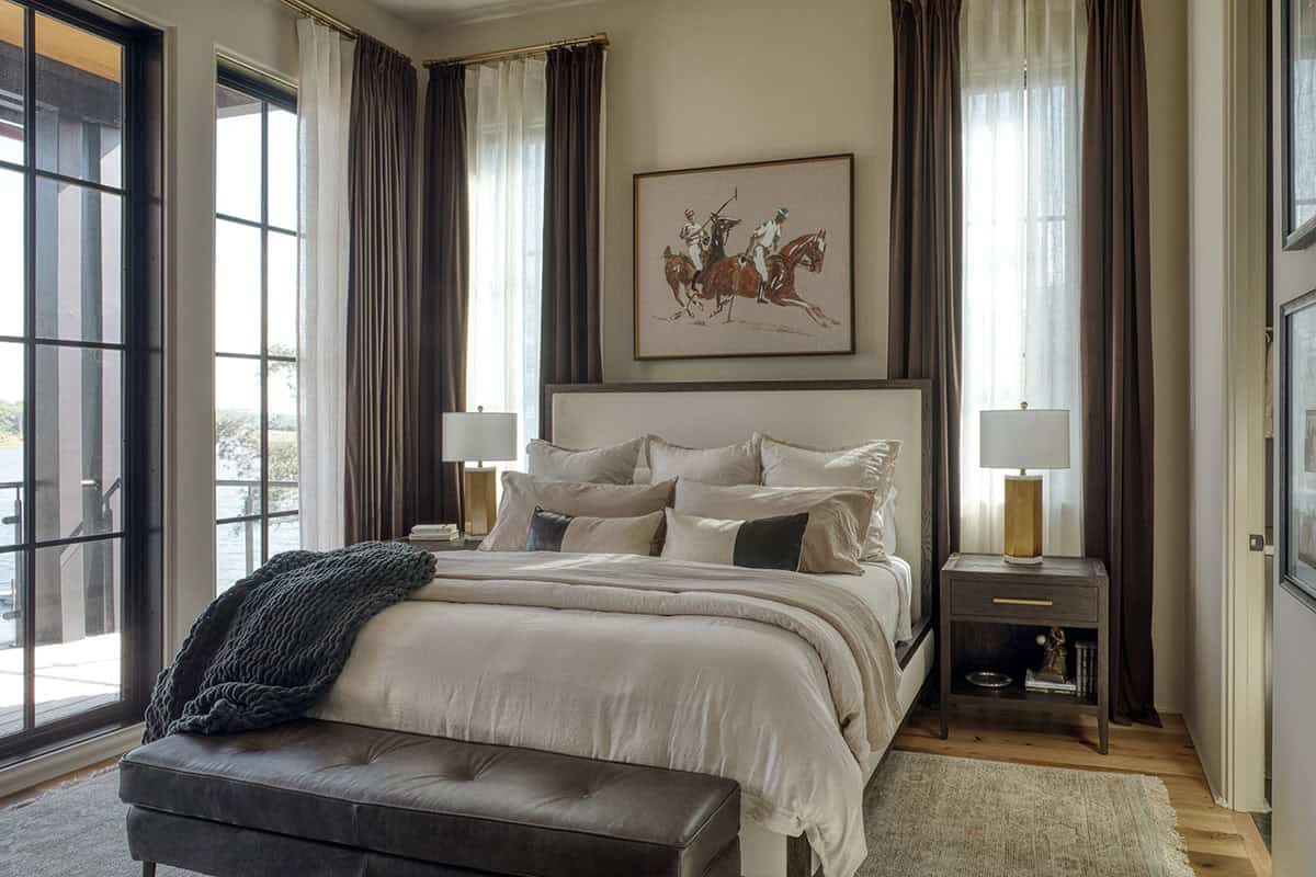 Guest bedroom with neutral tones lake views and equestrian artwork