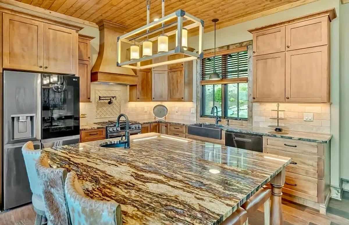 Gourmet kitchen island with dramatic granite countertop and wood cabinetry
