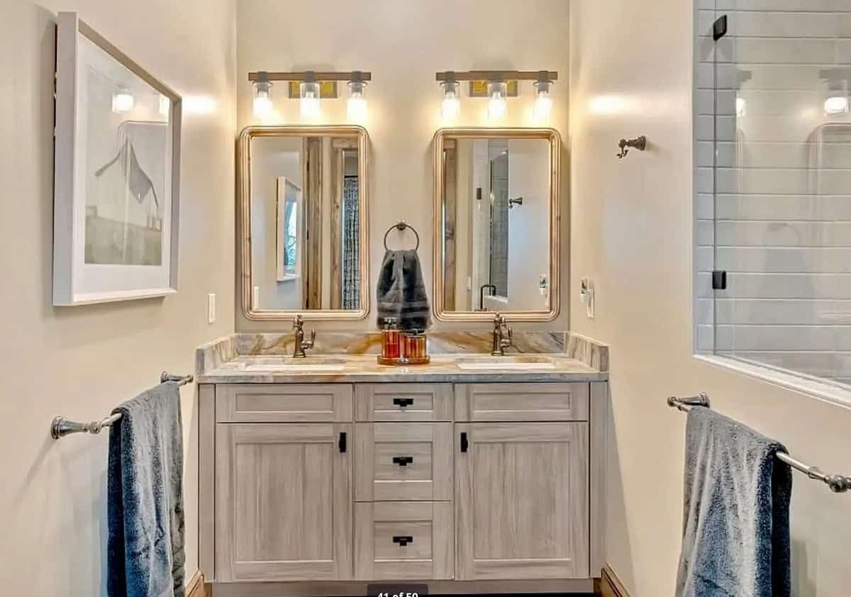 bathroom with a vanity and two mirrors