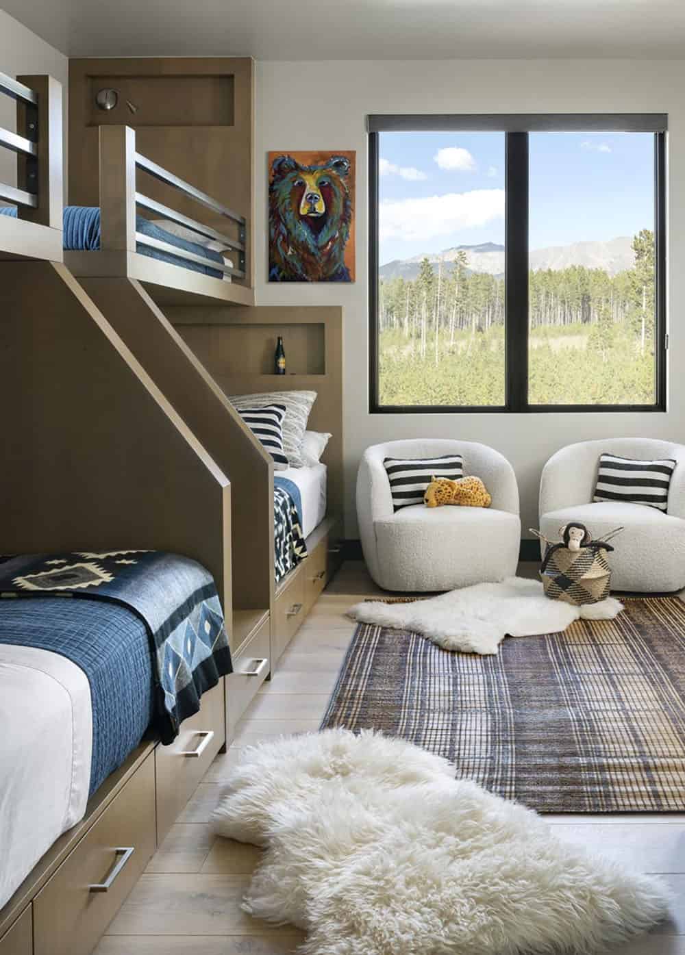 Kids bunk room with built-in wood bunks, plaid rug, and mountain window view