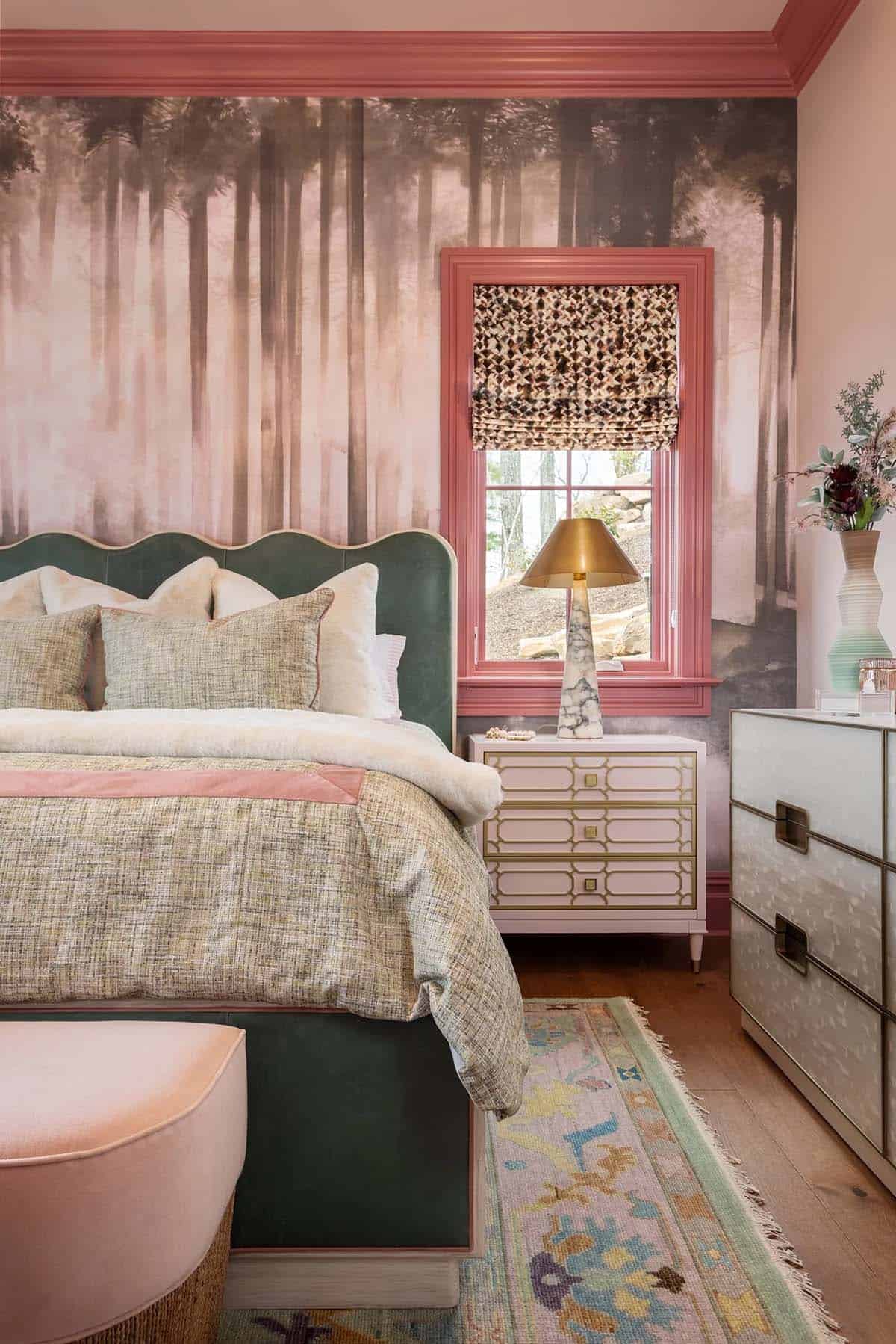 Girl's bedroom with misty forest mural wallpaper, green velvet headboard, and pink accents