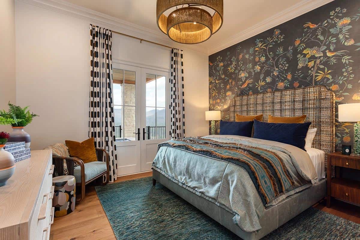 Guest bedroom with chinoiserie accent wall, tweed headboard, teal rug, and balcony doors