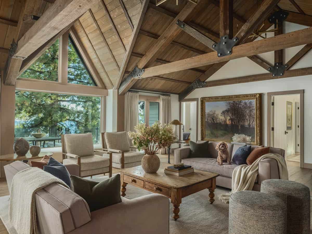 Lodge living room with exposed timber trusses, antique painting and golden retriever on sofa