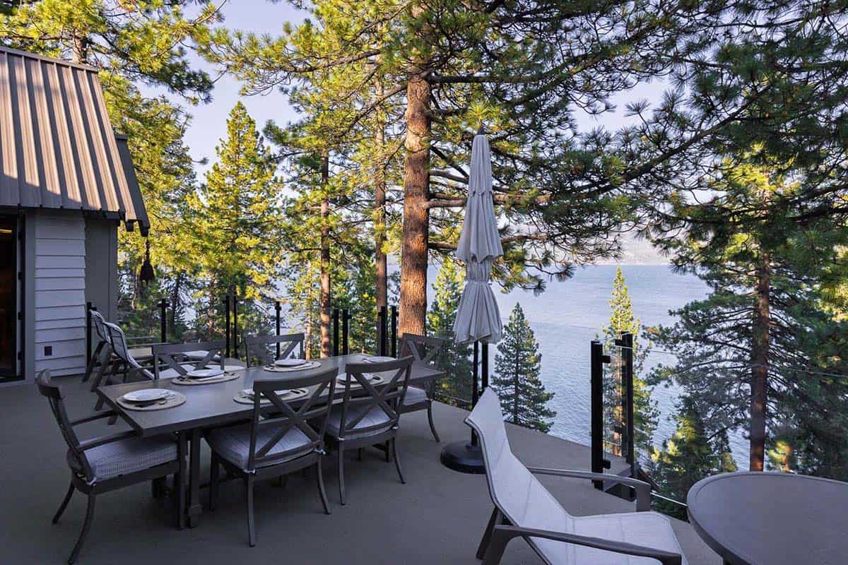 Mountain lodge home exterior deck with outdoor furniture overlooking Lake Tahoe