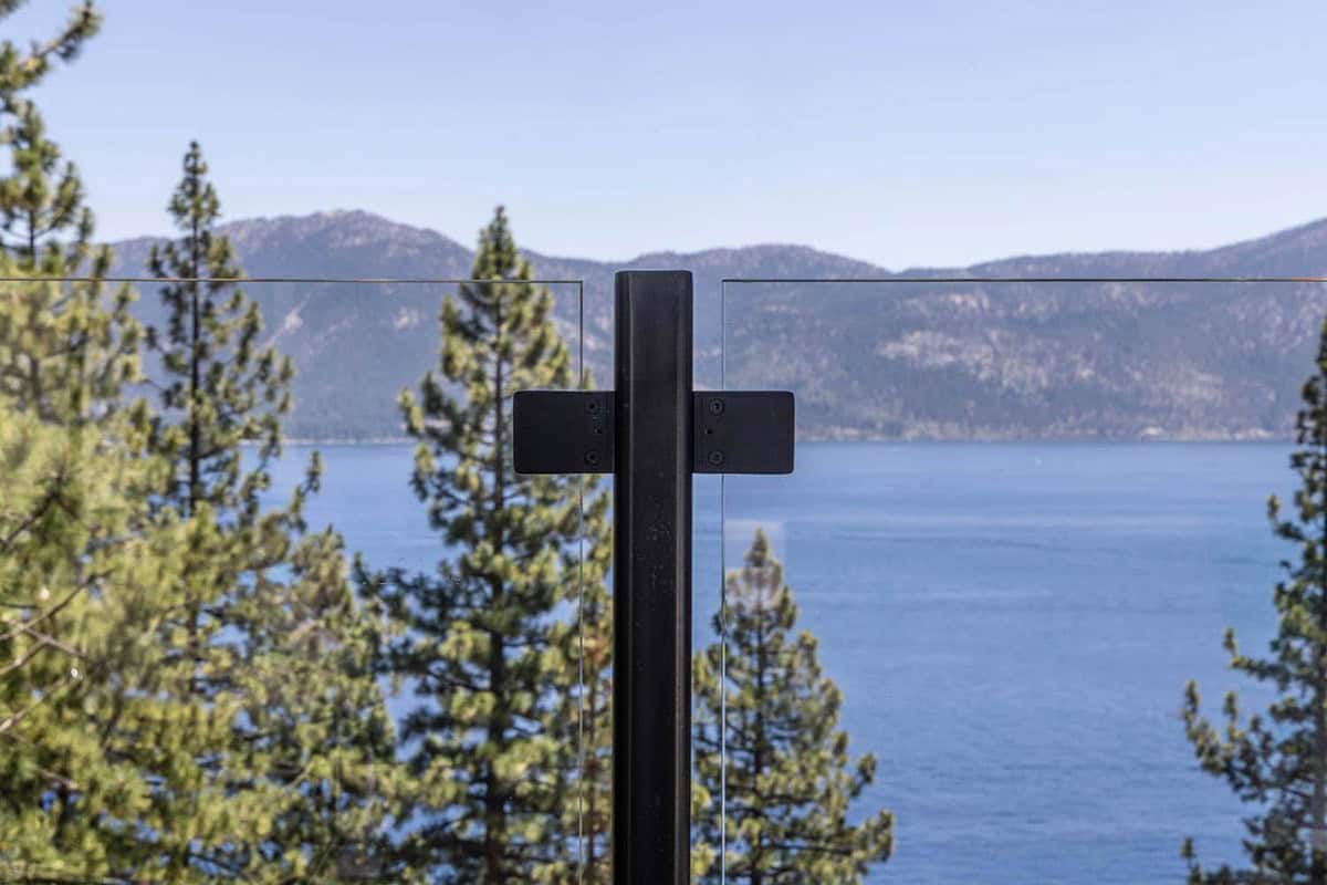 Mountain lodge home exterior deck glass railing detail overlooking Lake Tahoe
