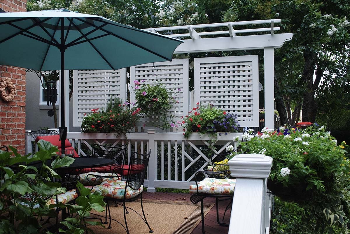 White lattice privacy screen panels with flower boxes on a deck