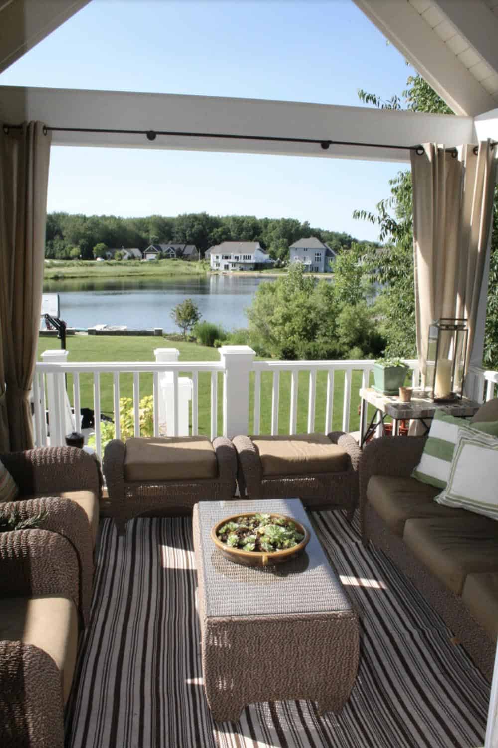 Deck with outdoor curtain privacy screen and lakefront views