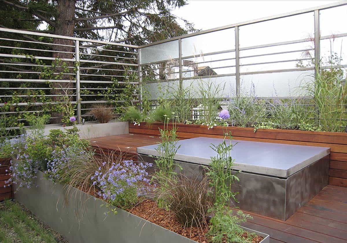 Modern deck with frosted glass and steel privacy screen raised planters and integrated hot tub