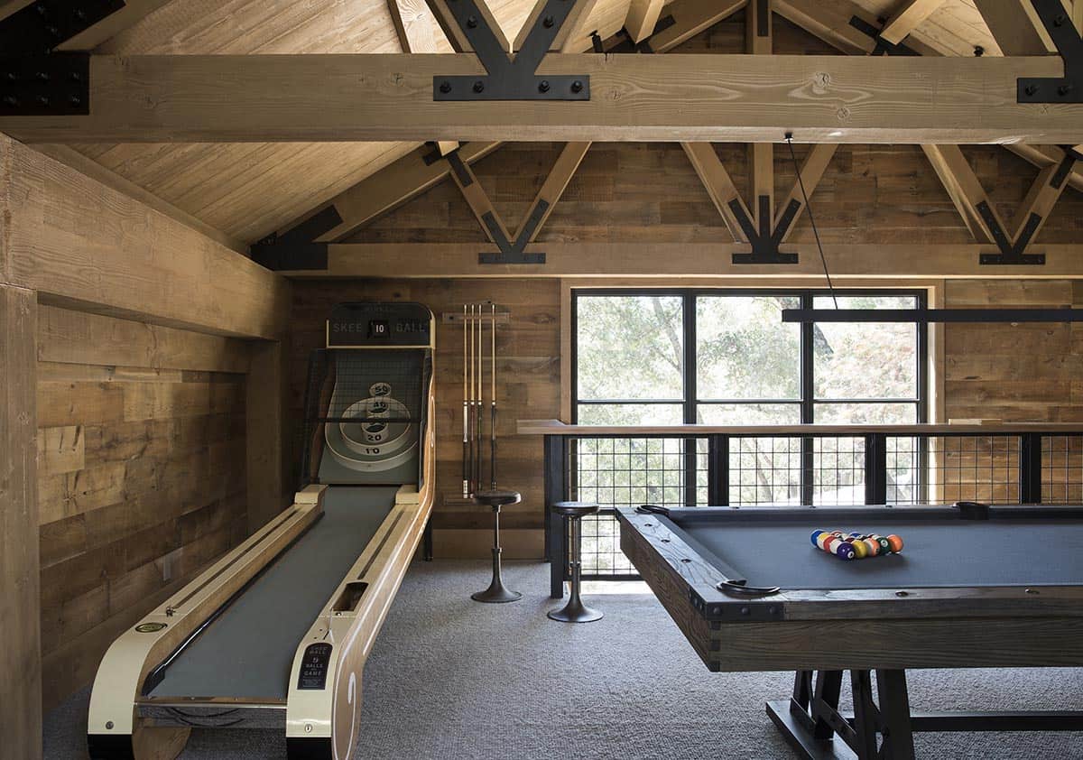 Mezzanine game room with skee-ball, pool table and exposed timber trusses