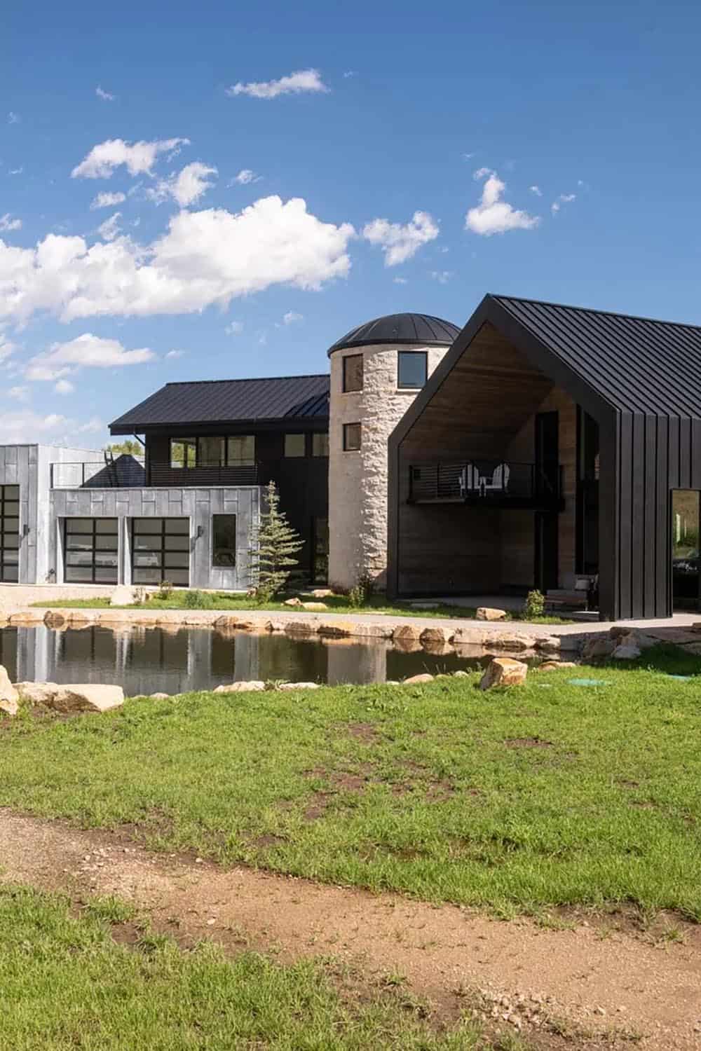 Full compound view showing silo, barn wing, and black standing-seam metal roof with trout pond, Utah