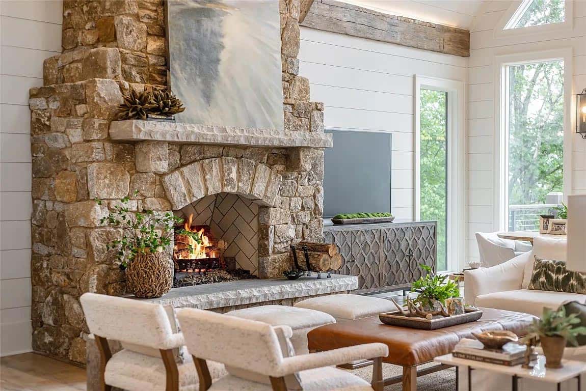 stone fireplace closeup, herringbone firebox tile, reclaimed wood beam, carved media cabinet, shiplap walls