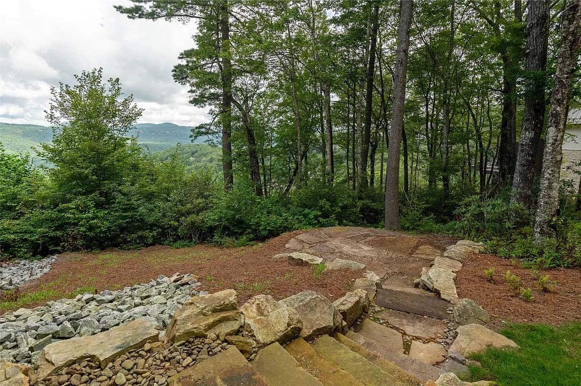mountain home exterior landscape with stone steps leading down the mountainside