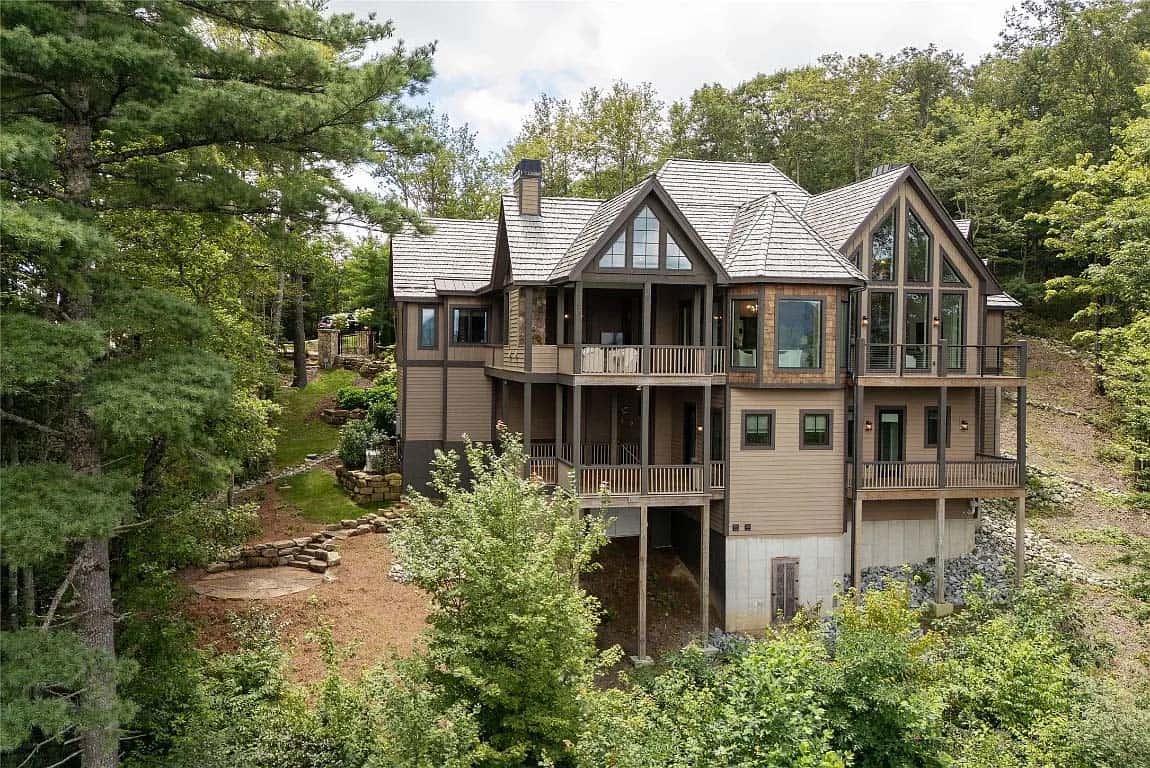 mountain home exterior backyard view surrounding by a dense forest