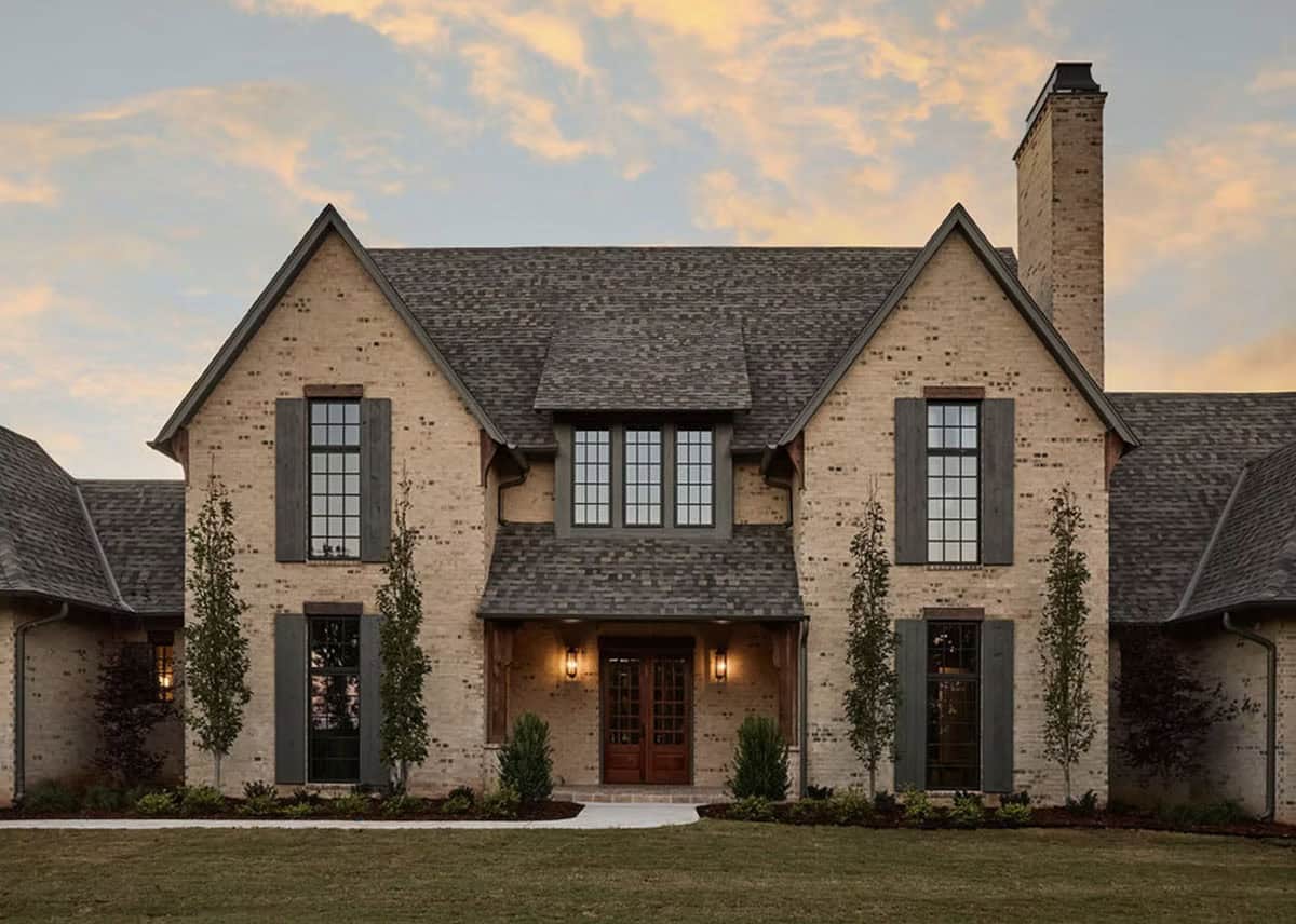 Rustic English-Inspired Brick Home Exterior at Dusk