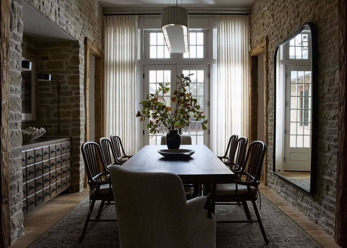 Stone-Walled Dining Room with Sheer Curtains and Arched Niches