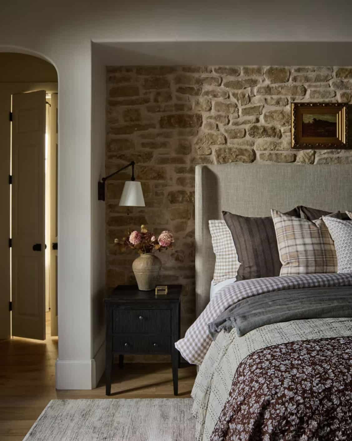 Bedside Vignette with Black Nightstand and Stone Wall