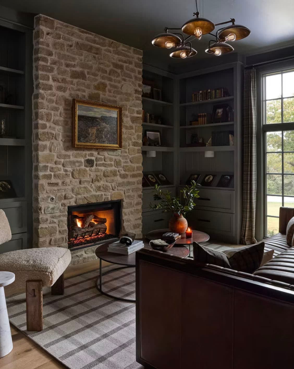 Moody Study with Stone Fireplace and Dark Built-In Bookshelves