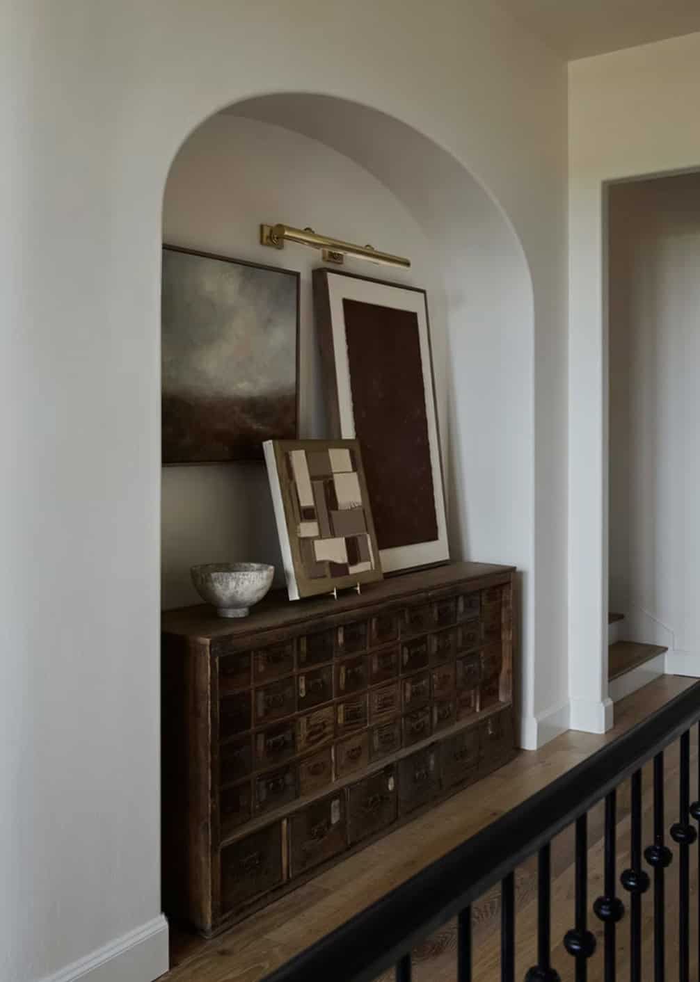 Hallway Arched Niche with Apothecary Cabinet and Layered Art