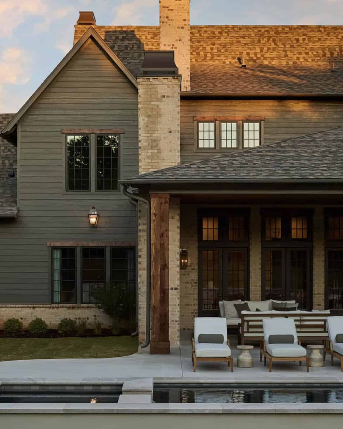 Rear Home Exterior at Dusk with Pool and Covered Patio