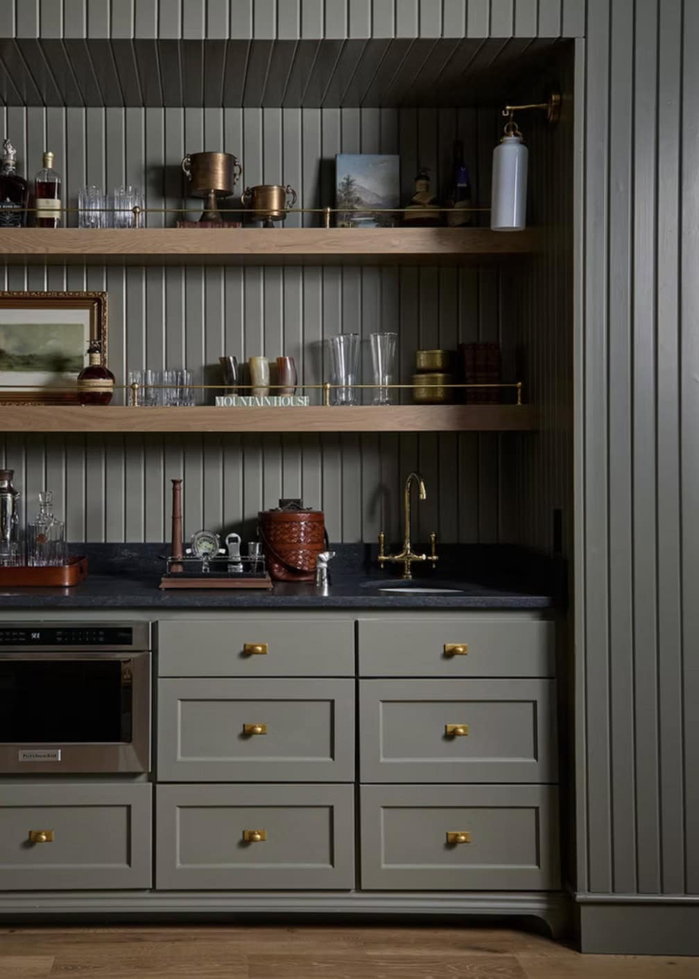 Sage Green Wet Bar Niche with Open Shelving and Brass Hardware