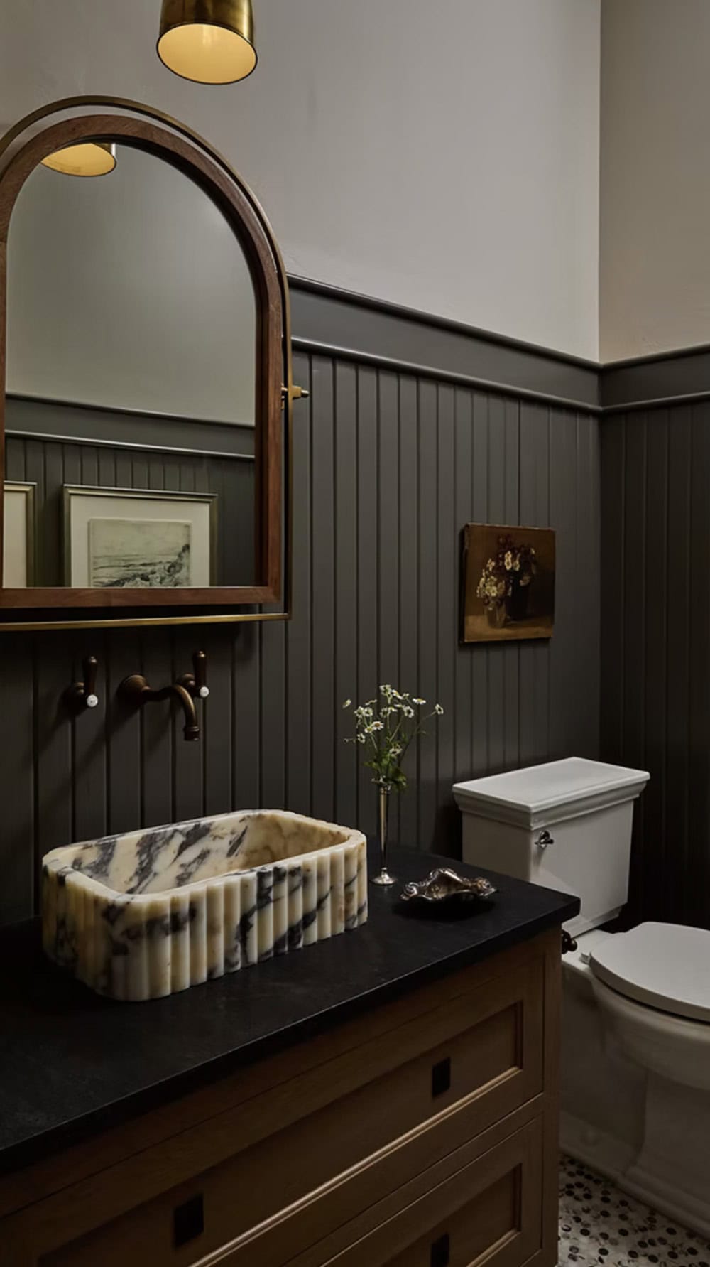Moody Powder Room with Marble Vessel Sink and Arched Mirror