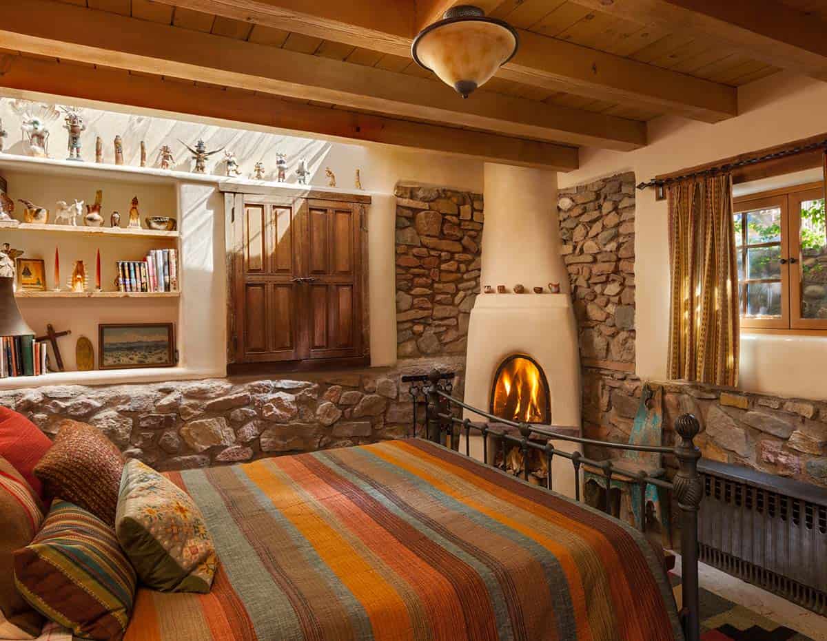 santa fe style bedroom with a fireplace