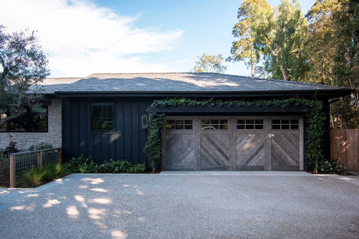 exterior garage, dark board and batten siding, reclaimed wood chevron garage doors, gravel driveway
