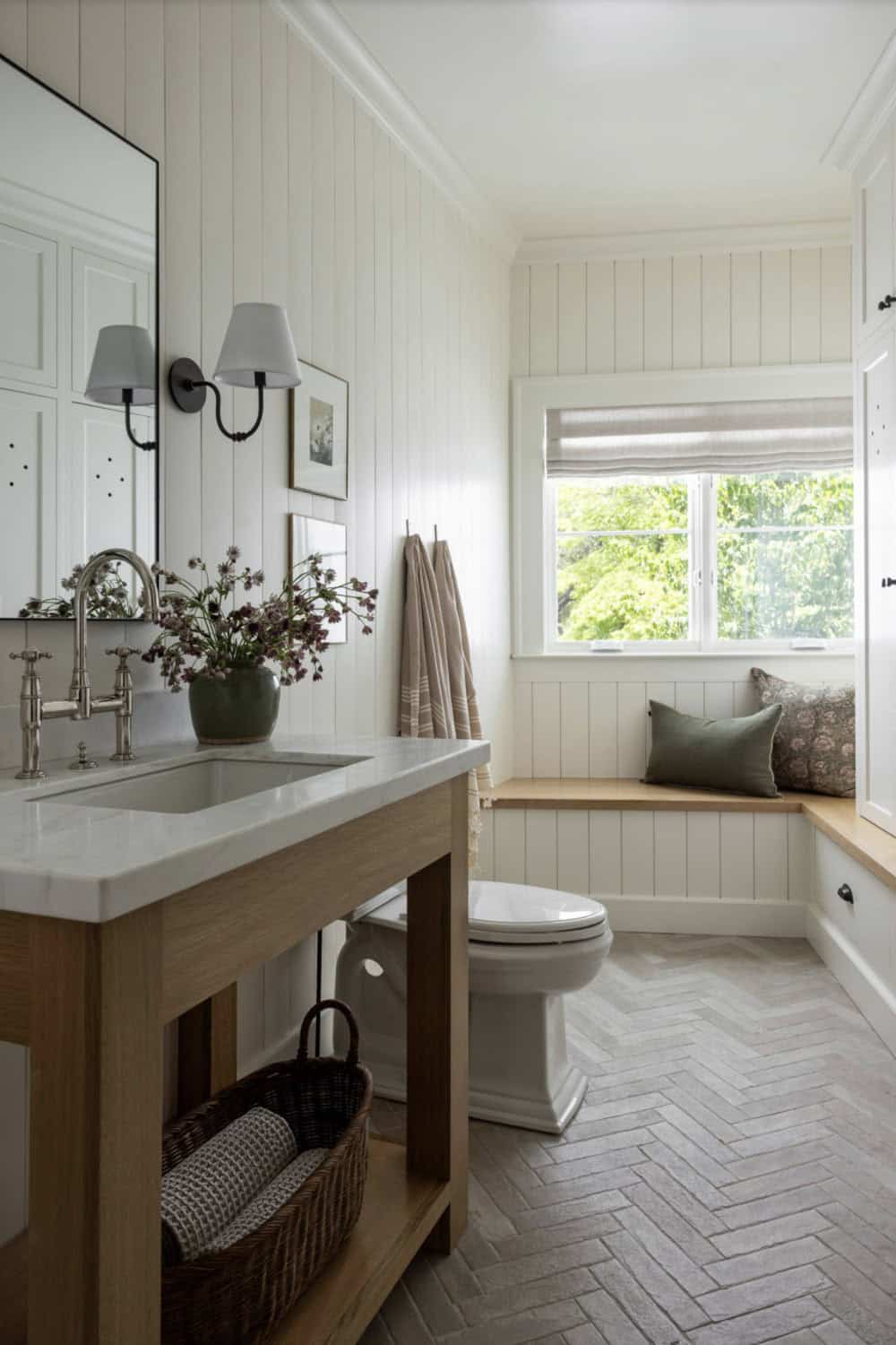 Bathroom vanity with marble counter, and built-in window seat